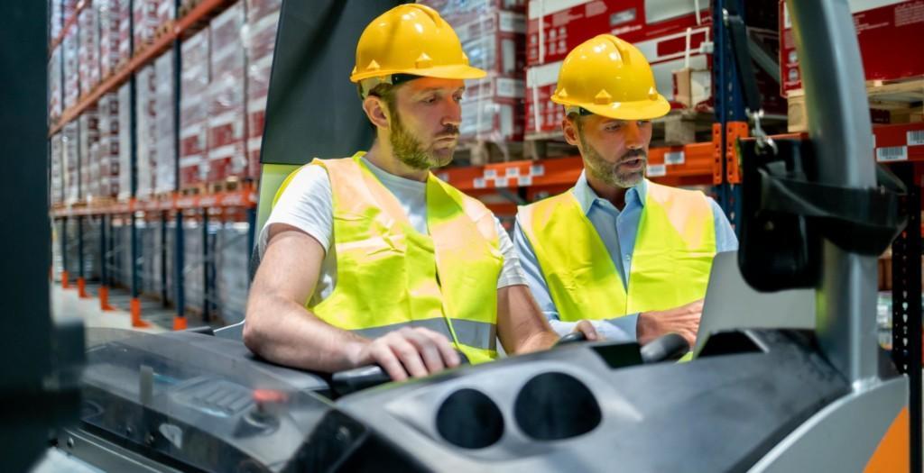 Two men controlling a machine